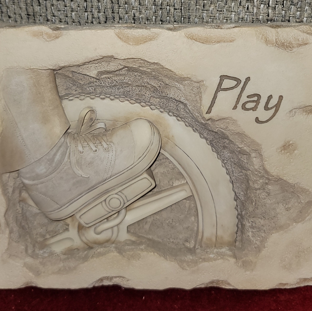 Play Plaque Featuring Child Peddling Bike